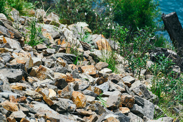 Gray old boulders on hillside. Danger of stone mudslide in highlands.