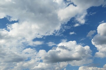 Beautiful white fluffy clouds in blue sky background