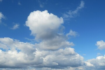 Beautiful fluffy clouds in blue sky background