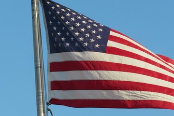 American flag on blue sky background