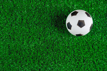 Soccer ball on green grass of field. Copy space.