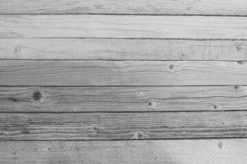 Gray table of narrow boards as background. Texture of old wood, cracks and knots