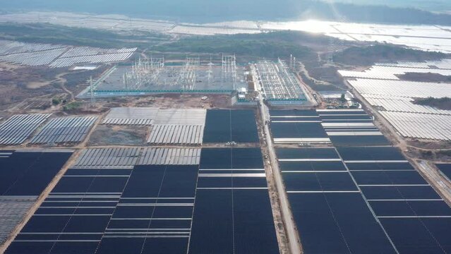 Ninh Thuan, Vietnam - May 15 2019: Aerial drone footage of a solar panel farm and substation generation alternative power - Green energy concept to reduce global warming and climate change