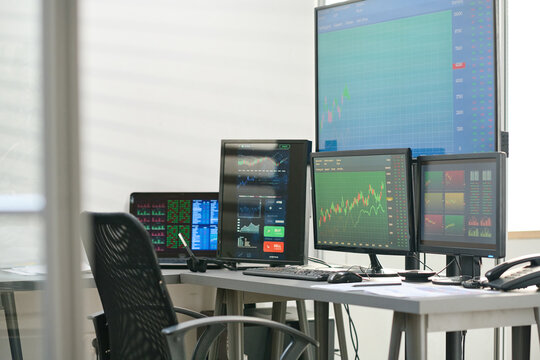 No People Shot Of Modern Stock And Currency Trading Specialists Workspace With Desk, Computer And Computer Monitors In Modern Office