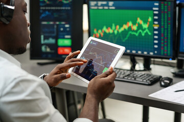High angle shot of unrecognizable man working on stock trading watching charts and graphs of currency