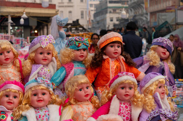 Beautiful cute baby girl dolls for sale at retail shop at Christmas market, New Market area, Kolkata, West Bengal, India.