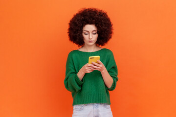 Portrait of attractive young adult woman with Afro hairstyle wearing green casual style sweater...
