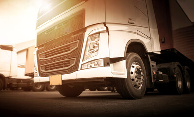 Semi TrailerTrucks Parked at The Warehouse. Shipping Diesel Trucks. Lorry Tractor. Industry Freight Trucks Logistics Cargo Transport.