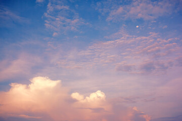 Naklejka na ściany i meble Pink clouds on blue sky with shining moon. Fabulous background for design. Wallpaper with fantastic morning sky.