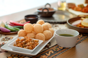Indian cuisine, panipuri is snack from India, curry butter chicken, chicken tikka, biryani, and naan bread on wooden table