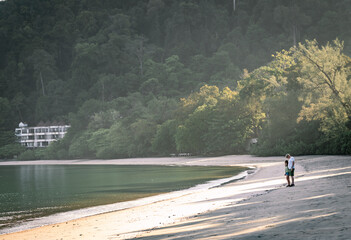 Father and Daughter having a walk on the beach, Langkawi Island, Malaysia