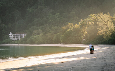 Father and Daughter having a walk on the beach, Langkawi Island, Malaysia