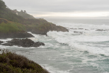 rocky cliff with fog and ocean waves