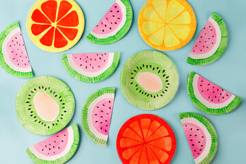 Fruit made of paper - watermelon, kiwi, lemon, grapefruit. Blue background. Tropics creative...