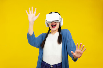 Asian woman in vr glasses isolated yellow background, playing video games with virtual reality headset, Metaverse Concepts
