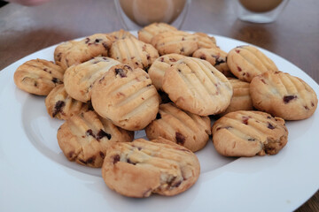 Homemade cranberry cookies just baked on a white plate. Soft focus image.