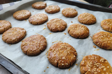 Homemade walnut cookies just baked on an oven tray.