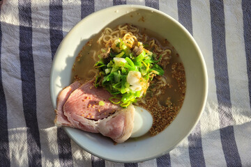 Home-cooked Japanese ramen  with char siu and fresh green scallions.