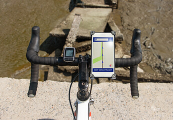 The handlebars of bicycle with incorrect navigation standing on the edge of a demolished way