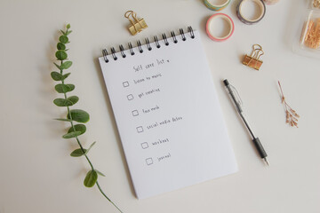 Text list for self care on notebook with pen on white background, office desk. - obrazy, fototapety, plakaty
