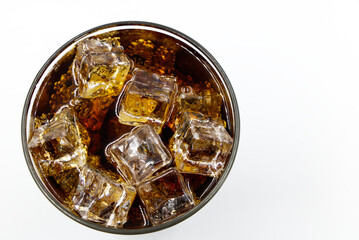 Cola glass with crushed on a white background cola ice in glass and there is water droplets around. cool black fresh drink.