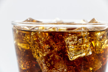 Cola glass with crushed on a white background cola ice in glass and there is water droplets around....