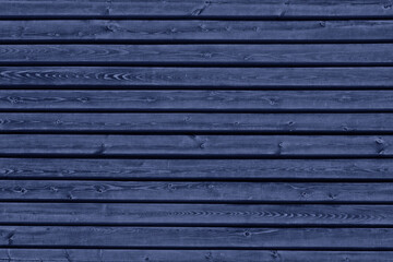 Navy blue wooden board wall texture. Old knotty wood panel indigo color dark blank textured background