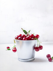 Cherries in a bucket on white background