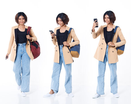 Full length of Asian Indian 20s working woman with curl hair hold cell smart phone backpack blazzer