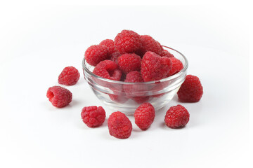 raspberries in a glass bowl isolated on a white background