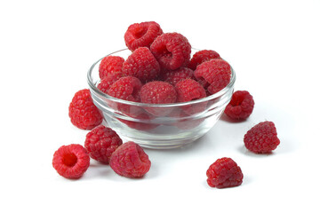 raspberries in a glass bowl isolated on a white background