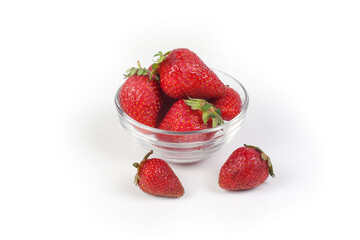 strawberries in a glass bowl isolated on a white background