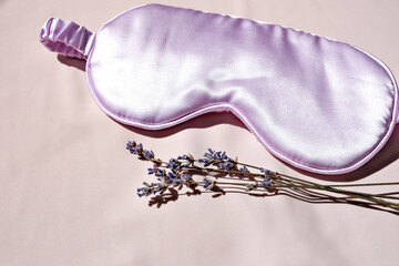 Sleep mask with natural lavender on the bed. Side view, space for text.