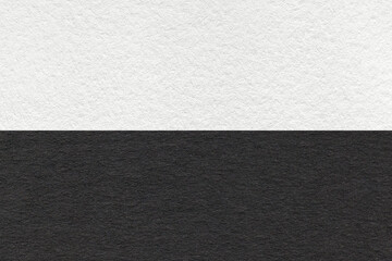 Fototapeta premium Texture of craft black and white paper background, half two colors, macro. Structure of vintage dense cardboard.