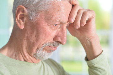 Obraz premium Portrait of sad sick senior man at home