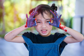 Little cute girl showing painted hands ,Portrait of a cute cheerful girl have fun painting her hands