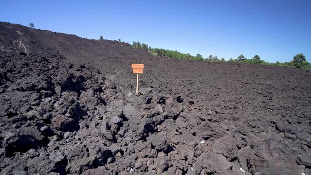 Panning on black rocks of lava flow in Piano Provenzana in Sicily, Italy.
