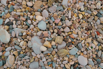 colorful pebbles and stones on the beach. textured natural background