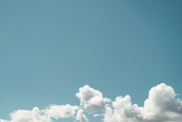 Nature, sky landscape. White lush clouds on blue light sky on sunny summer day outdoors. Minimalism, copy space