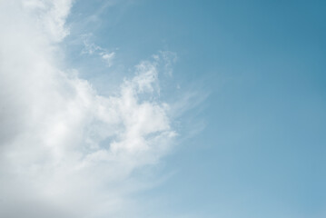 White soft clouds on blue sky on sunny summer day in windy weather outdoors, copy space. Nature, weather, sky landscape