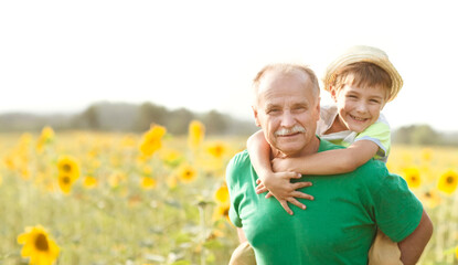  Concept of friendly family.  grandfather and grandson spend time together in nature. Copy space...