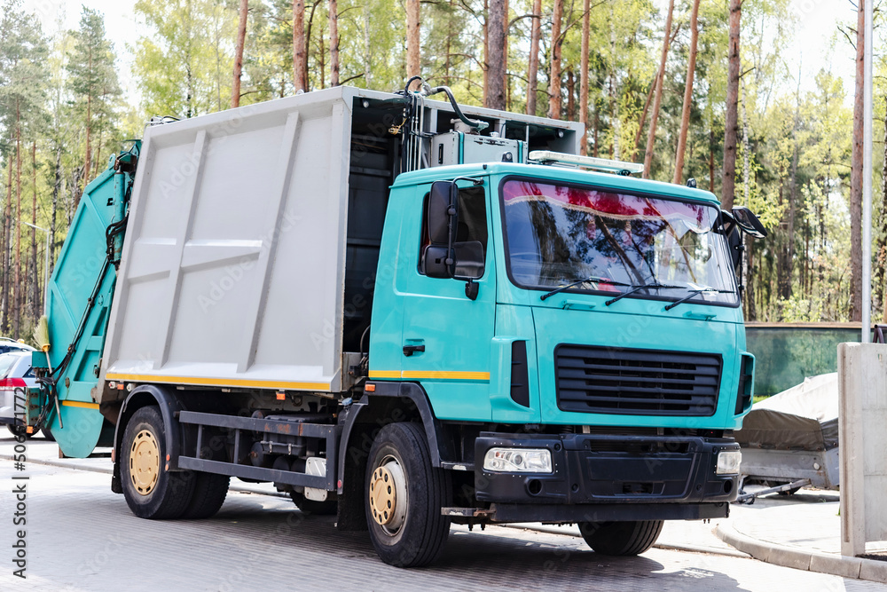Leinwandbilder a garbage truck picks up garbage in a residential area. loading mussar in containers into the car. s