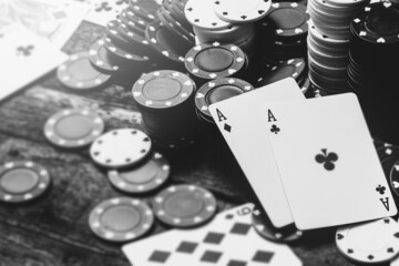 Monochrome image of two aces and a lot of casino chips