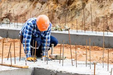 Construction of a residential area. Geodetic stakeout. Surveyor at a large construction site. A man with a tachometer during work. Makshader