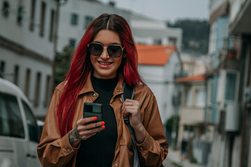 red hair tourist woman around the city with phone and backpack