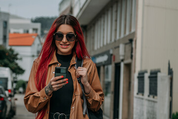 Fototapeta na wymiar red hair tourist woman around the city with phone and backpack