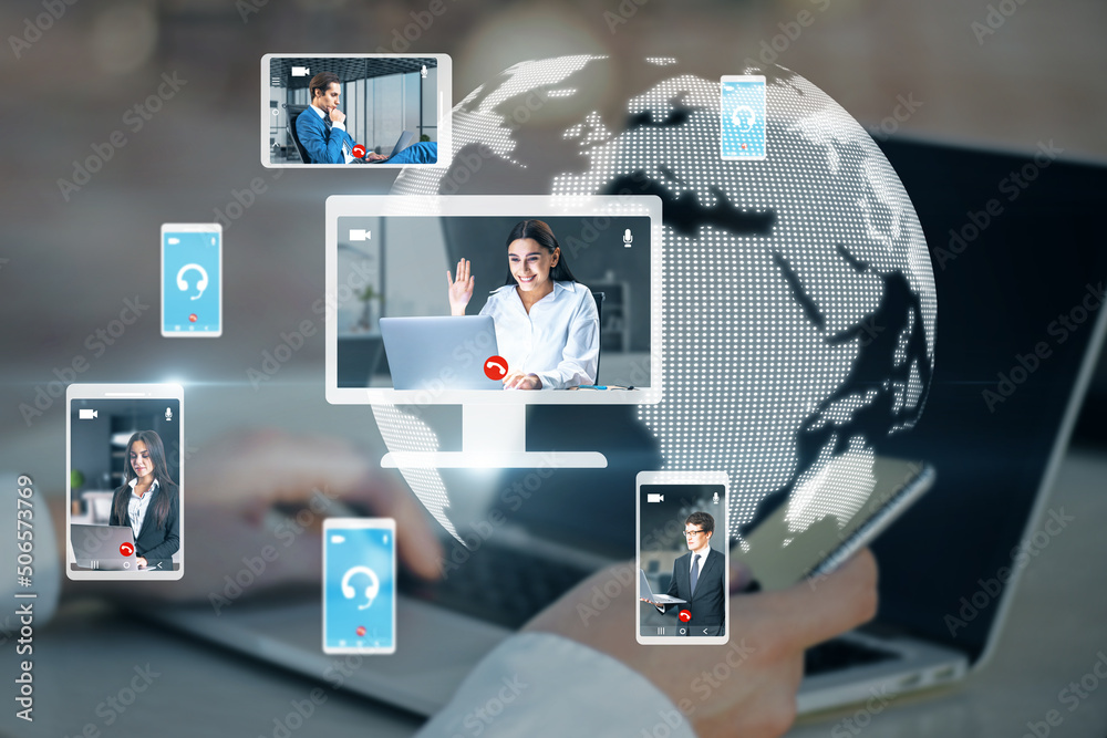 Poster hands at workplace with devices and creative globe map with computer screens and creative video conference call between attractive young european businesspeople. Blurry backdrop. 