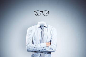 Headless invisible businessman with folded arms and abstract glasses standing on gray wall...