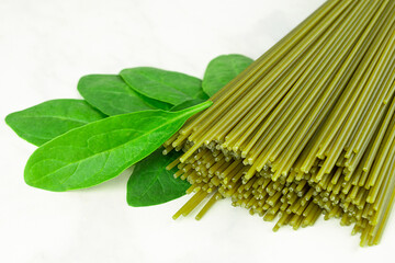 close up Fresh spaghetti with spinach leaf on gray background