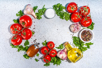 Obraz na płótnie Canvas Cooking ingredients background. Spices, black pepper, garlic, onion, greens, tomatoes. olive oil on white stone concrete table top view copy space. Preparation healthy food background.
